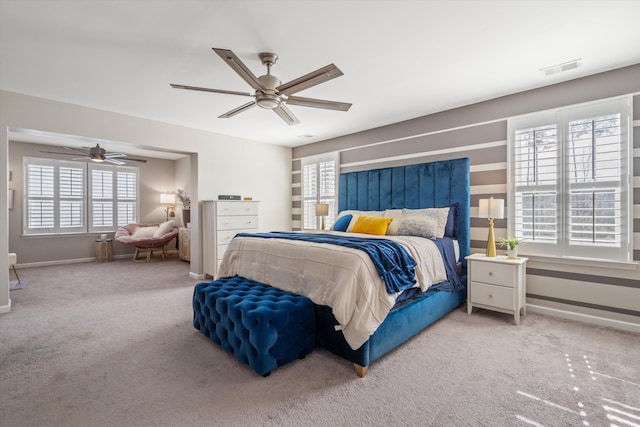 bedroom with carpet flooring, ceiling fan, visible vents, and baseboards