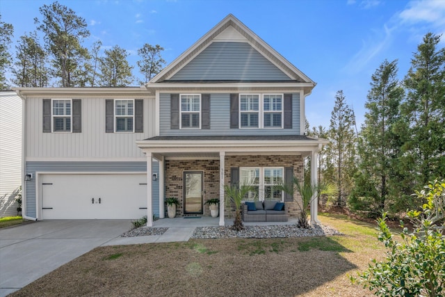 view of front of property featuring driveway, covered porch, an attached garage, and brick siding