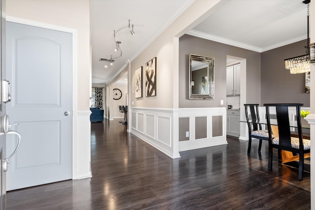 hall with dark wood-style flooring, visible vents, crown molding, and a decorative wall