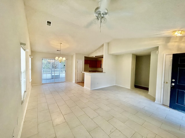 unfurnished living room with visible vents, ceiling fan with notable chandelier, baseboards, and lofted ceiling