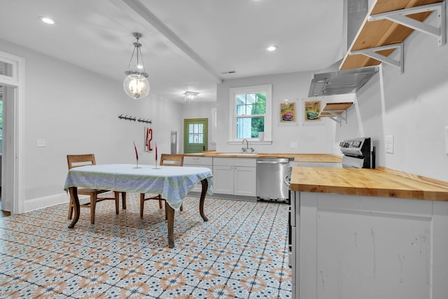 2122 Tugaloo Ave Unit 2120, Columbia, SC 29205 - kitchen with butcher block counters, stainless steel dishwasher, a sink, hanging light fixtures, and white cabinetry