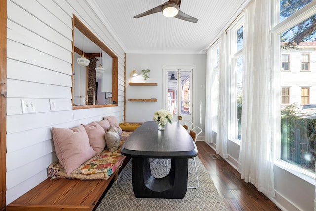 sunroom / solarium featuring a ceiling fan and a healthy amount of sunlight