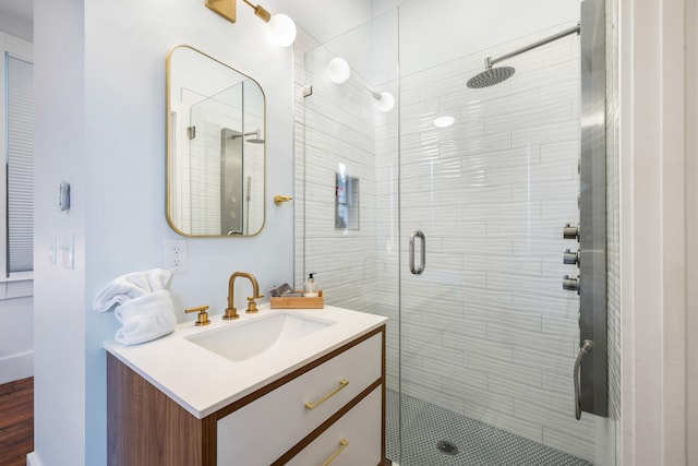 bathroom with a shower stall and vanity