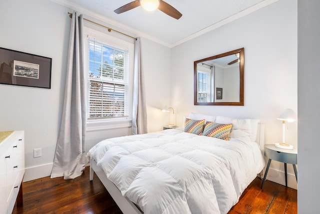 bedroom with ornamental molding, a ceiling fan, hardwood / wood-style flooring, and baseboards