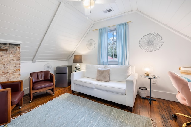 sitting room with baseboards, visible vents, vaulted ceiling with beams, and hardwood / wood-style floors