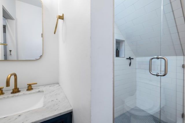 full bath featuring lofted ceiling, a shower stall, and vanity