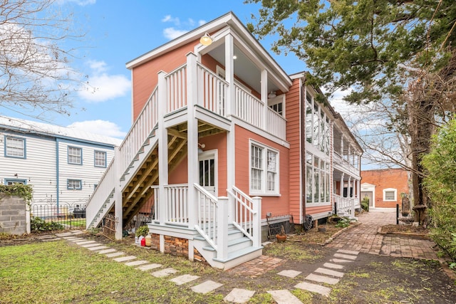 rear view of property with fence and a lawn