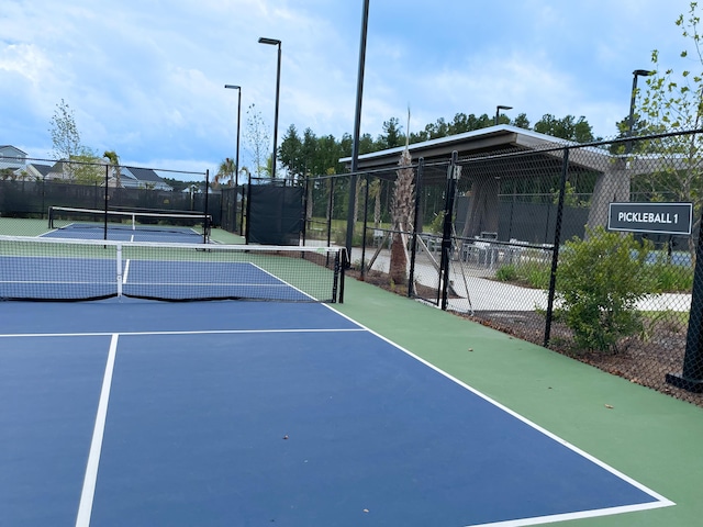 view of tennis court with fence