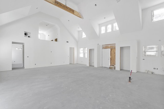 unfurnished living room with a high ceiling