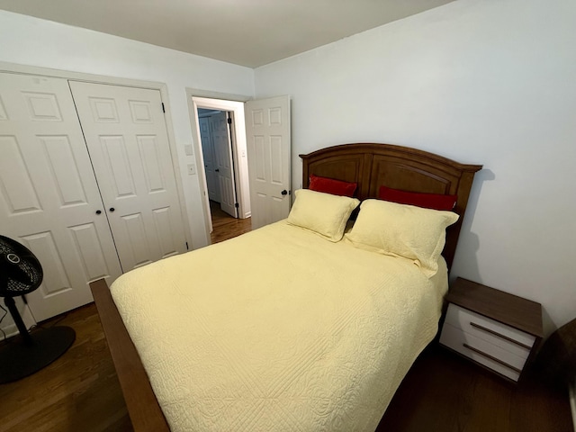 bedroom featuring dark wood finished floors and a closet