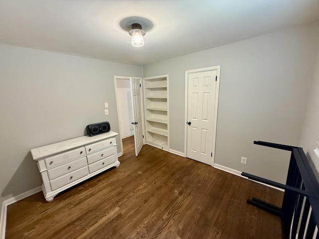 bedroom featuring dark wood finished floors and baseboards