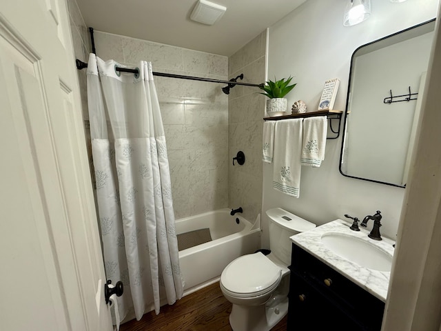 bathroom featuring toilet, shower / tub combo, wood finished floors, visible vents, and vanity