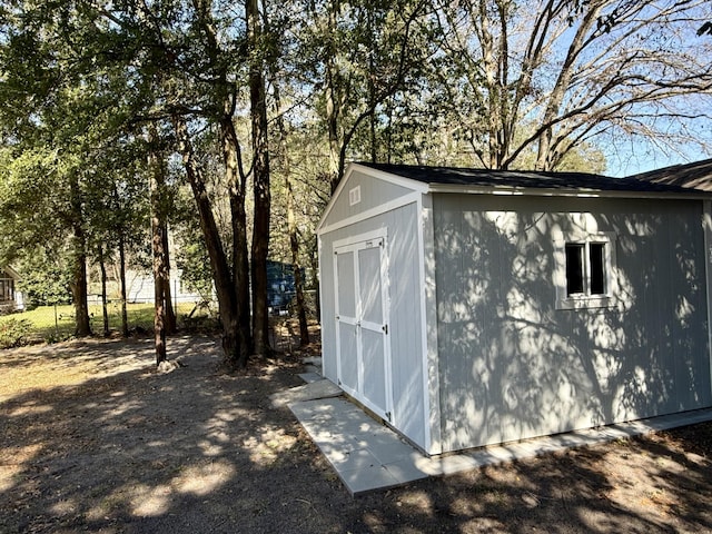 view of shed featuring fence