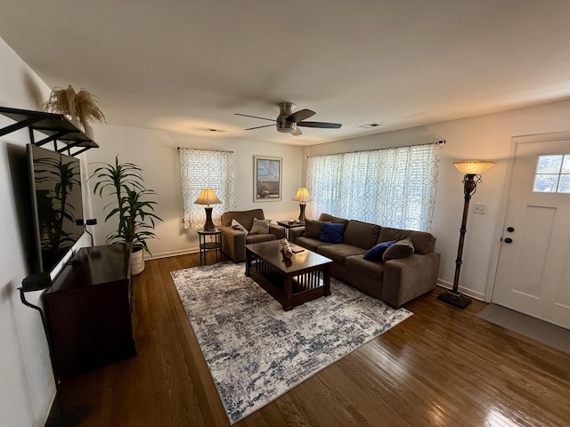 living area with ceiling fan, dark wood-style flooring, visible vents, and baseboards