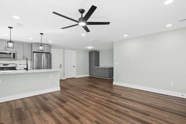 unfurnished living room with dark hardwood / wood-style flooring and ceiling fan