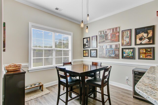 3801 Canary Ct, North Charleston, SC 29420 - dining area with crown molding, light wood-type flooring, and baseboards