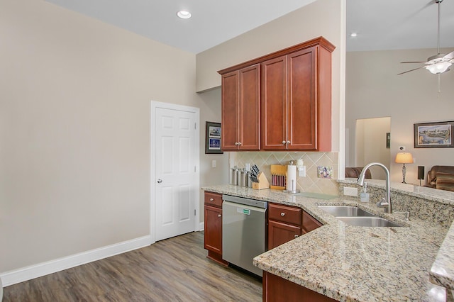 3801 Canary Ct, North Charleston, SC 29420 - kitchen with stainless steel dishwasher, a sink, wood finished floors, a ceiling fan, and light stone counters