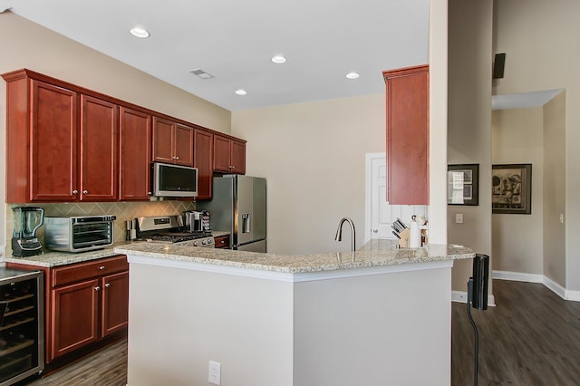 3801 Canary Ct, North Charleston, SC 29420 - kitchen with appliances with stainless steel finishes, wine cooler, dark wood-type flooring, tasteful backsplash, and recessed lighting