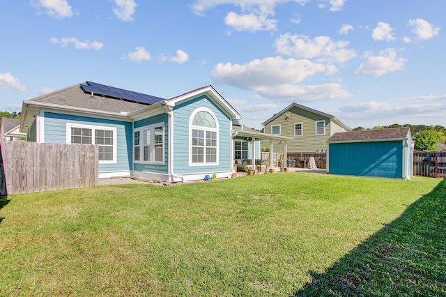 3801 Canary Ct, North Charleston, SC 29420 - back of house featuring roof mounted solar panels, an outbuilding, and a storage shed