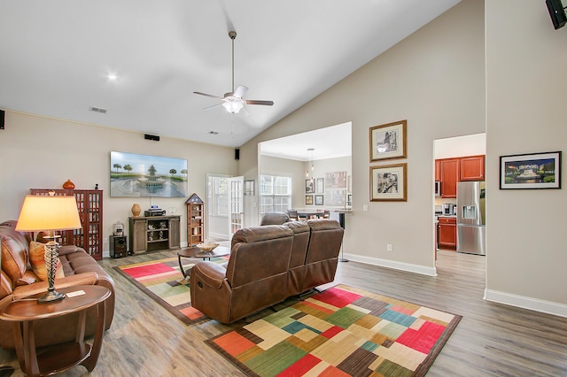 3801 Canary Ct, North Charleston, SC 29420 - living room with light wood finished floors, ceiling fan, baseboards, and high vaulted ceiling