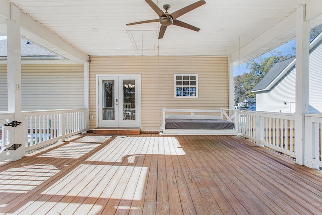 wooden deck with ceiling fan and french doors