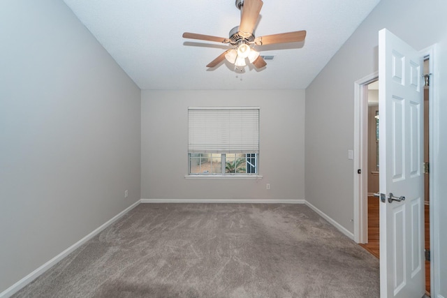 empty room featuring carpet floors and vaulted ceiling