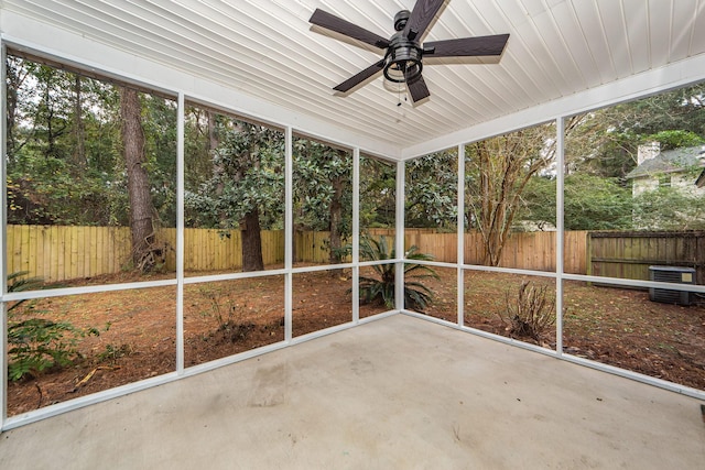 unfurnished sunroom with ceiling fan