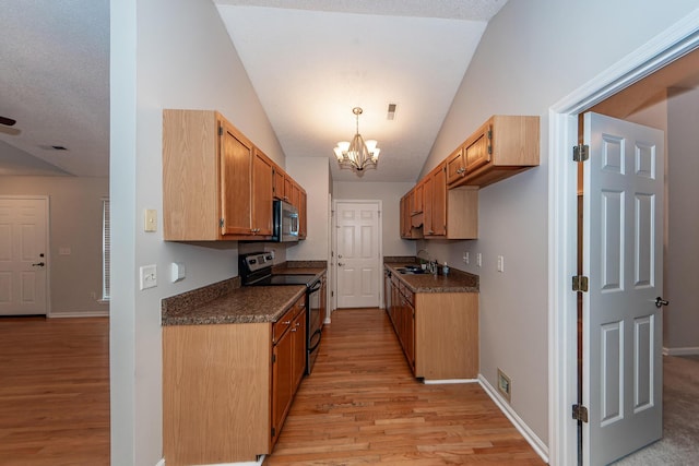 kitchen featuring black range with electric cooktop, vaulted ceiling, sink, an inviting chandelier, and light hardwood / wood-style flooring