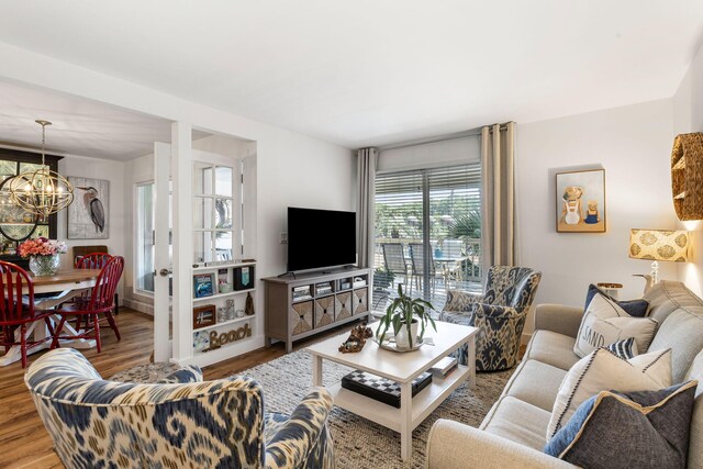 living room featuring a chandelier and wood-type flooring