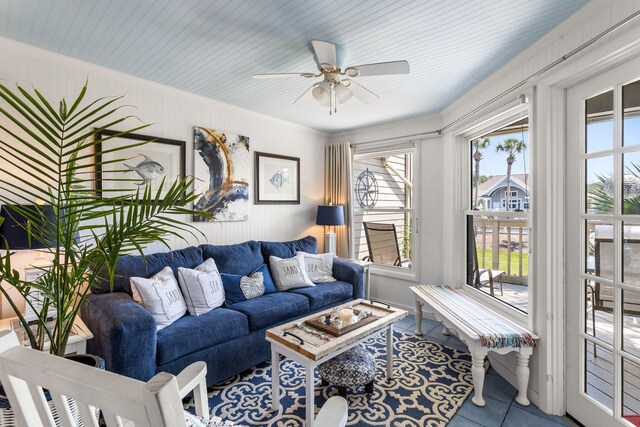 tiled living room with ceiling fan