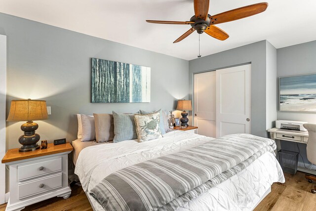 bedroom featuring ceiling fan, a closet, and hardwood / wood-style floors