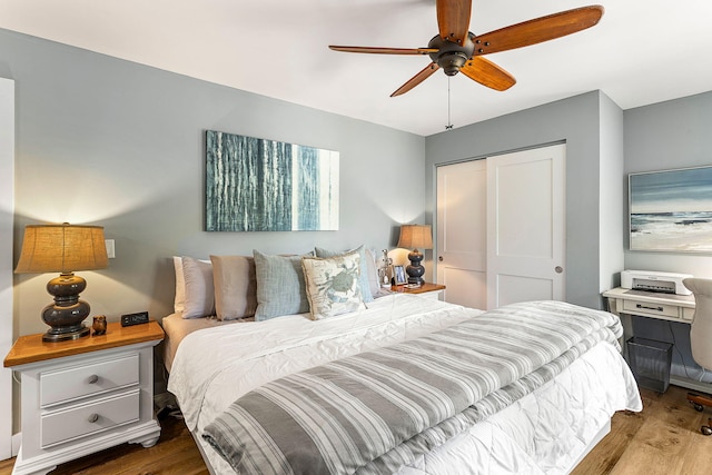 bedroom featuring wood finished floors, a closet, and ceiling fan