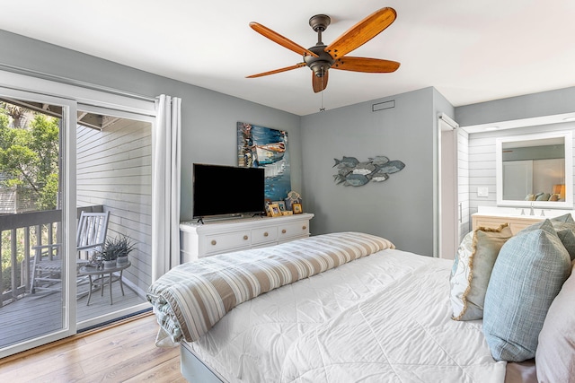 bedroom featuring access to outside, wood finished floors, and ceiling fan