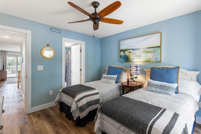 bedroom with ceiling fan, baseboards, and wood finished floors