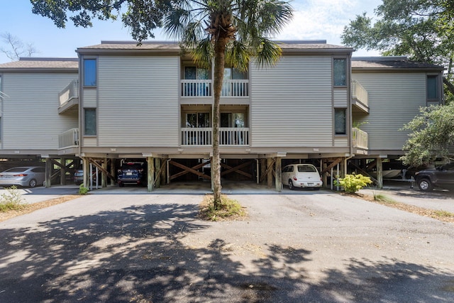 rear view of property with a carport and driveway