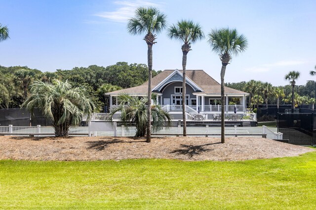 rear view of property with a lawn