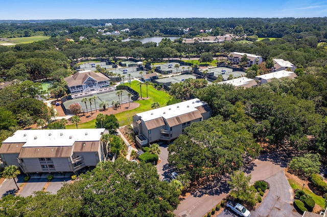 aerial view featuring a wooded view and a water view