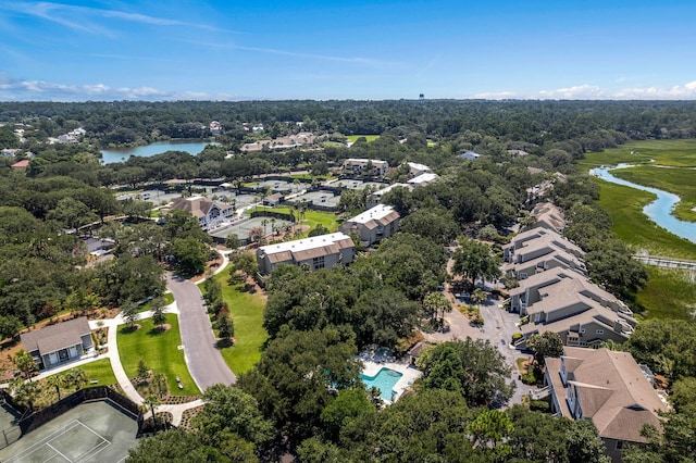 birds eye view of property with a wooded view, a water view, and a residential view