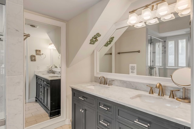 bathroom with a sink, double vanity, and a stall shower