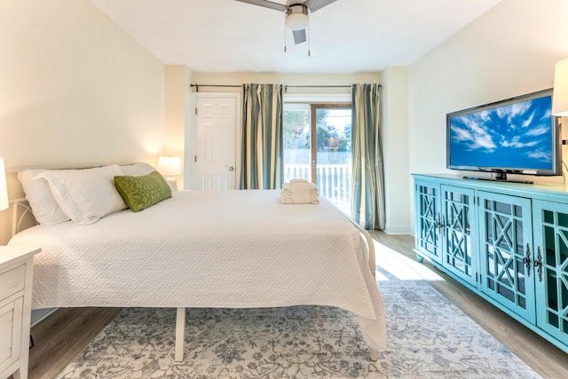 bedroom featuring access to outside, wood finished floors, baseboards, and a ceiling fan