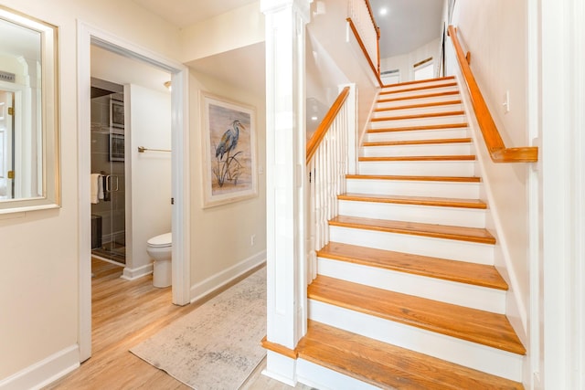 stairs with baseboards and wood finished floors