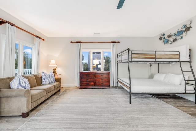 bedroom featuring ceiling fan, wood finished floors, and baseboards