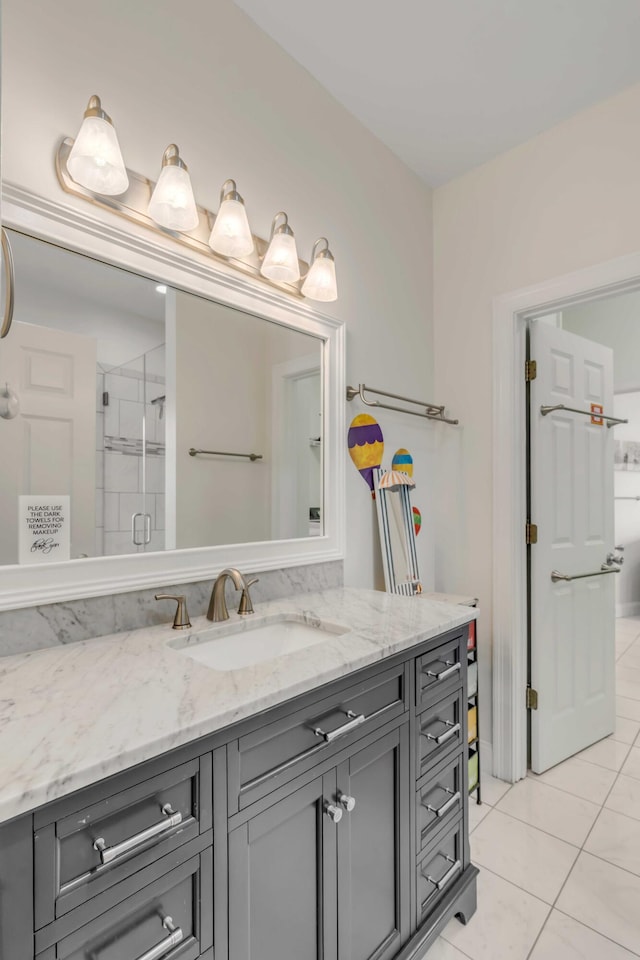 full bath featuring a shower stall, vanity, and tile patterned flooring