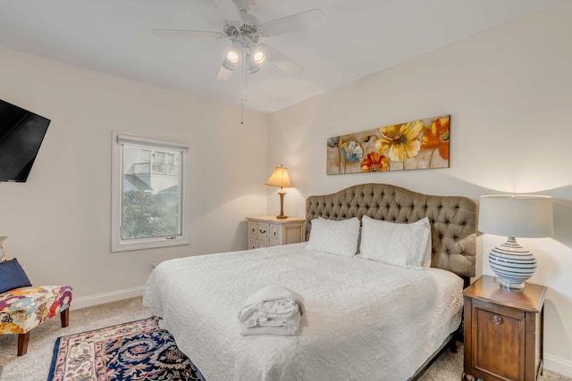 carpeted bedroom featuring baseboards and a ceiling fan