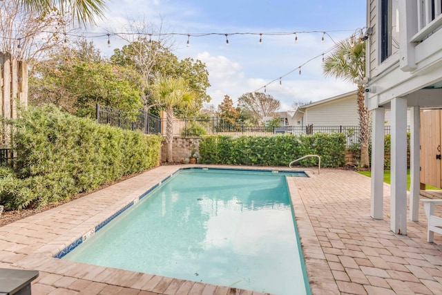 view of swimming pool with a patio area, a fenced backyard, and a fenced in pool