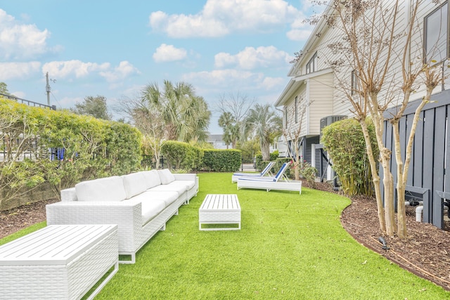view of yard with fence and an outdoor hangout area