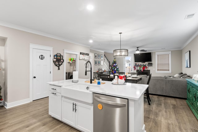 kitchen with white cabinets, ceiling fan, decorative light fixtures, dishwasher, and an island with sink