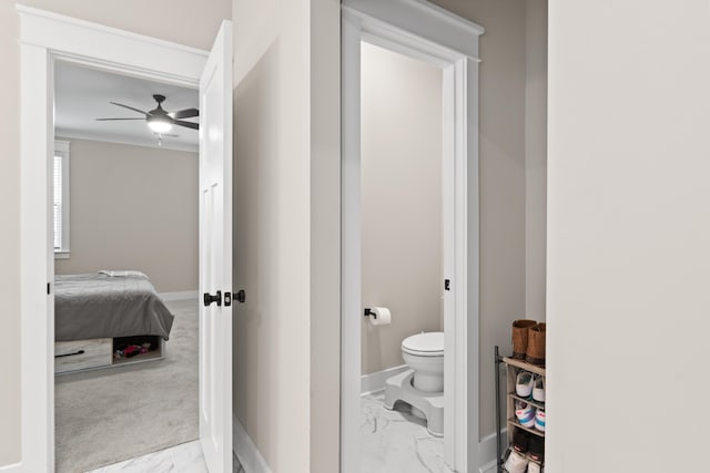 bathroom with ceiling fan, ornamental molding, and toilet