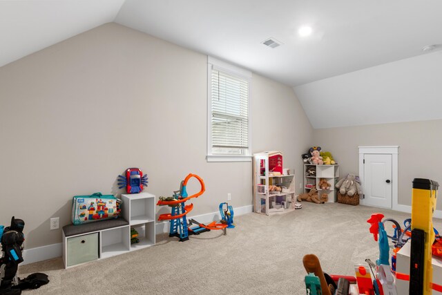 game room featuring carpet and vaulted ceiling