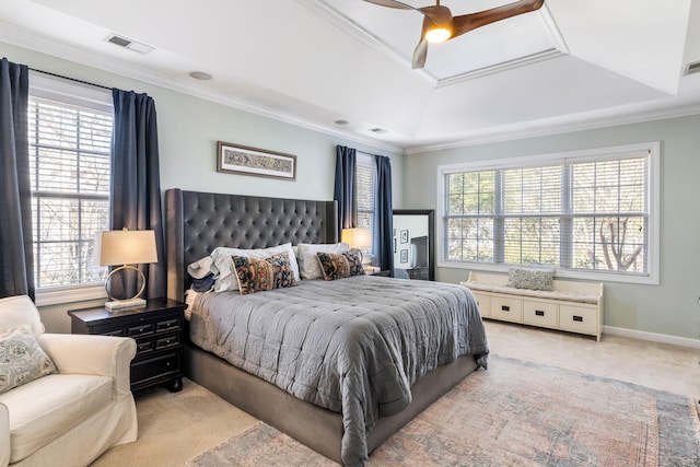 carpeted bedroom with multiple windows, visible vents, a tray ceiling, and ornamental molding